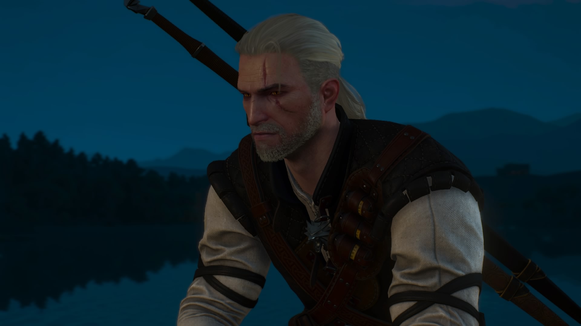 A close up of Geralt, a man with long white hair pulled back, as he sits by a lake in the woods. From The Witcher 3 video game.